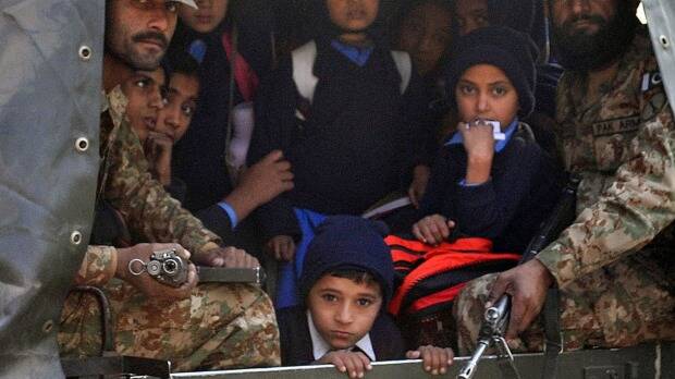 Pakistani soldiers transport rescued school children from the site of an attack by Taliban. Photo: AFP
