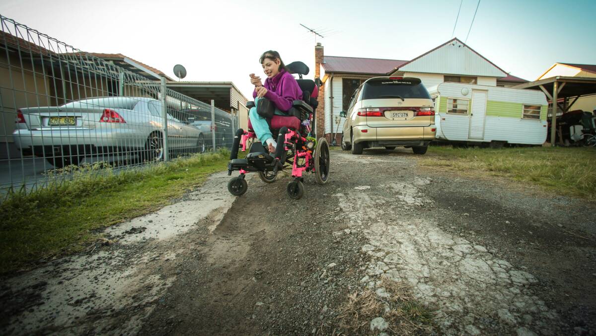 Uneven and unsuitable: Courtney Massey in the driveway of her Berkeley home. Picture: ADAM McLEAN