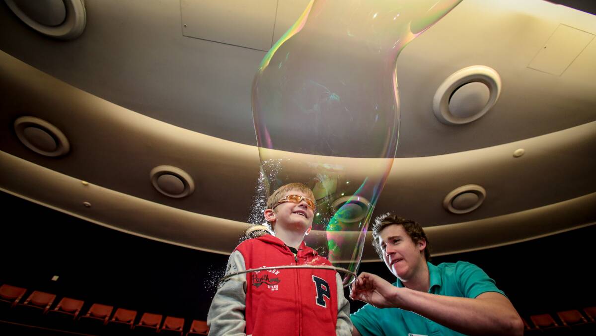 Ryley Jenkins puts Cemeron McDonald into a bubble at the Science Centre in Fairy Meadow. Picture: ADAM McLEAN