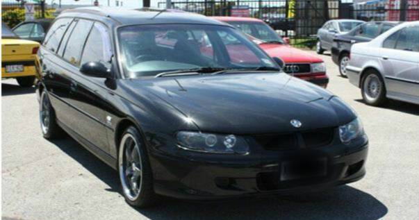 A dark Holden Commodore station wagon similar to the one police are looking for in relation to a Bomaderry armed robbery.