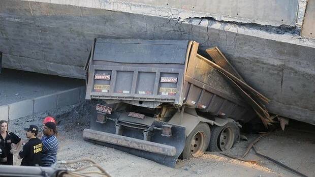 A truck is pinned underneath the collapsed bridge in Belo Horizonte. Photo: AP
