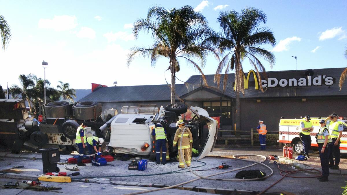 The truck rolled over near McDonald's at Fairy Meadow at the bottom of Mt Ousley Road. Picture: SYLVIA LIBER