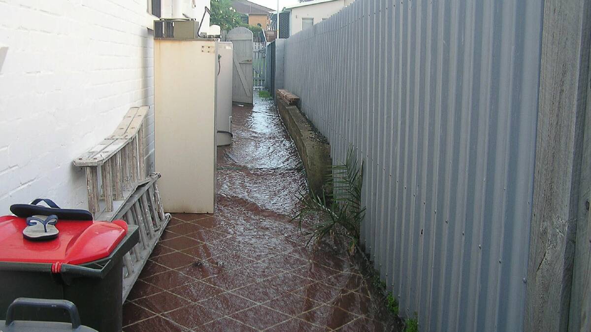 Three homes were flooded after a water main burst on Quarry Street, Port Kembla on Tuesday. Picture: BOB PARKES