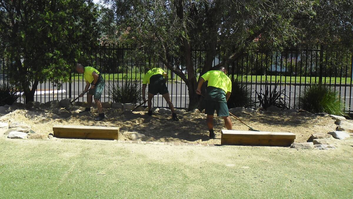Hard labour: Crew from the South Coast Correctional Centre at work at Peterborough School in Warilla.