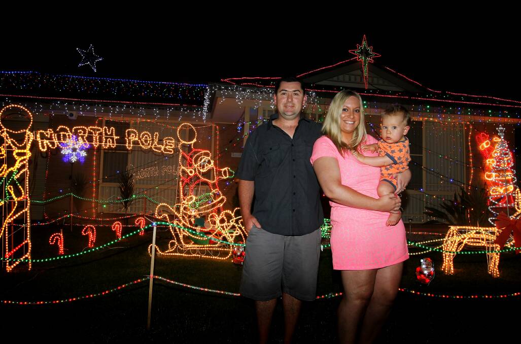 The winners of last year’s Mercury Christmas lights competition, Nathian and Elleni Mackay, with 23-month-old son Lachlan, getting their house ready for the festive season. Picture: SYLVIA LIBER