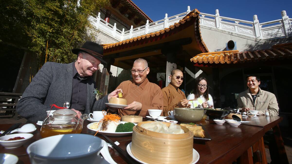 Gathering: Gordon Bradbery,  Miao You,  Man Wang, Bella Ge and Zan Zhang sit down for a meal at the Nan Tien Temple during the launch of the Dinner Table Project. Picture: ROBERT PEET