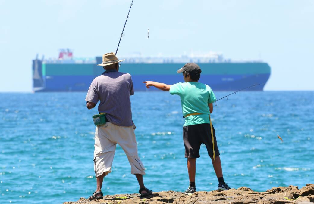 Fishing on rocks north of Wollongong City Beach. Picture: KIRK GILMOUR