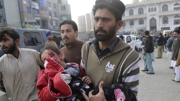 A Pakistani girl, who was injured in a Taliban attack in a school, is rushed to a hospital in Peshawar. Photo: AP