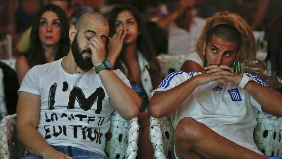 Greece fans in Athens react as they watch a live broadcast of Greece's World Cup match against Costa Rica. Picture: REUTES