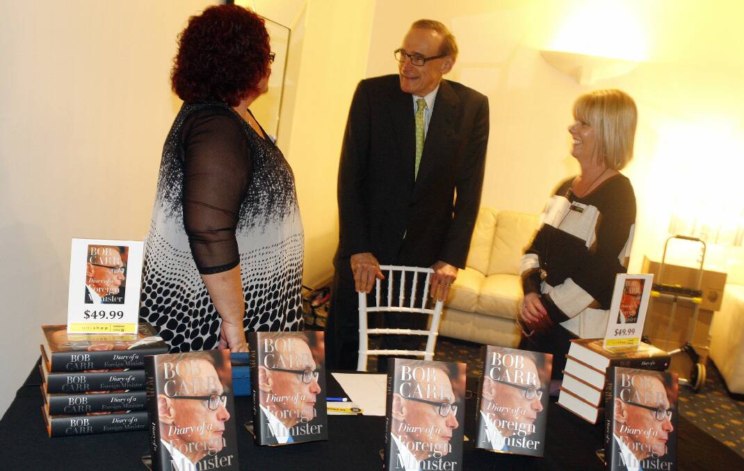 Bob Carr meets with UniCentre bookstore employees Robyn Oliveira and Lisa Murphy. Picture: ANDY ZAKELI 