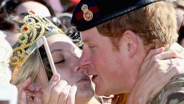When Harry met Vicky: Prince Harry is kissed by royal fan Victoria McRae during a walkabout outside the Sydney Opera House. Photo: Getty Images