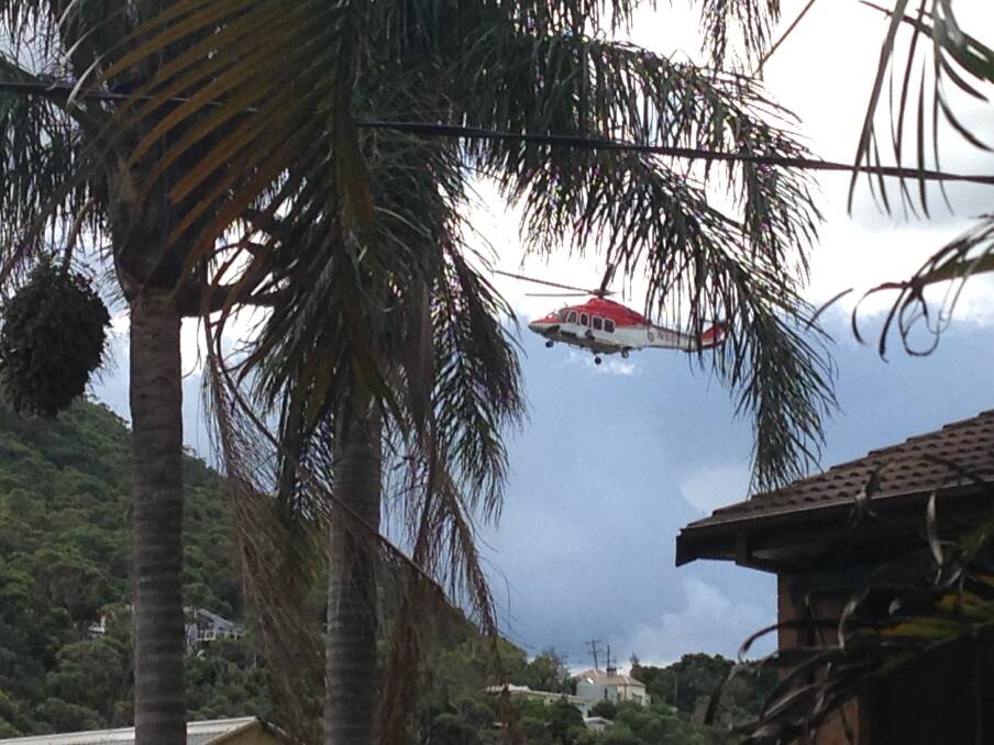 The ambulance helicopter searches for somewhere to land. Picture: DEREK REED