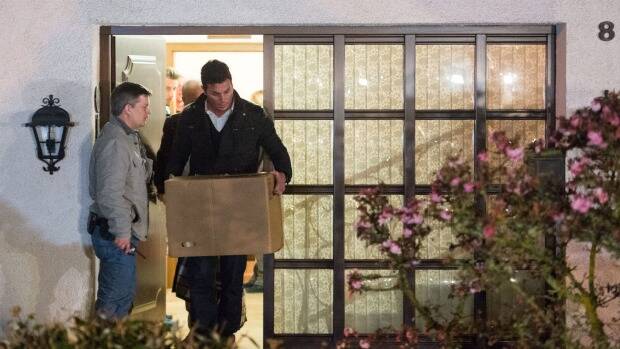 Police carry computer, a box and bags out of the residence of the parents of Andreas Lubitz, co-pilot on Germanwings flight 4U9525 in Montabaur, Germany. Photo: Getty Images