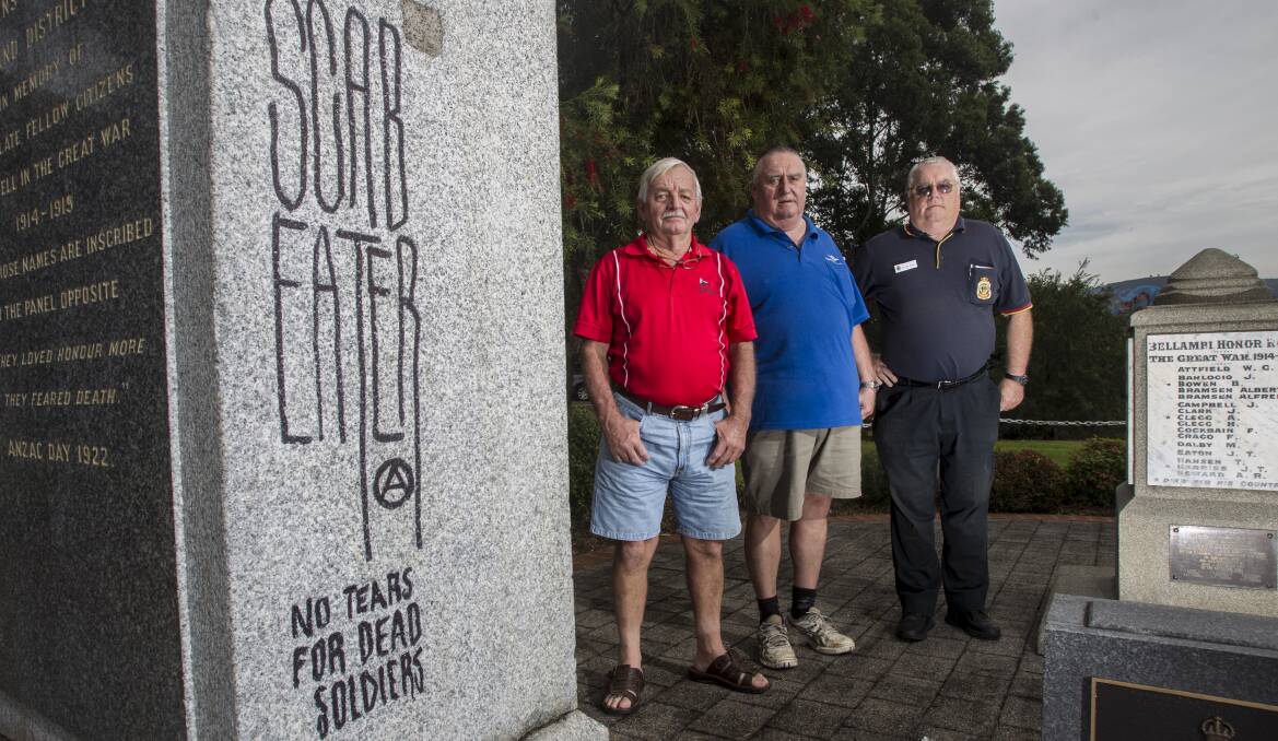 Corrimal sub-branch vice-president Neil Mclean, treasurer Harry Bassett and welfare officer Ray Morgan at Corrimal’s war memorial where vandals have knocked a large chunk out of a granite pillar and scrawled offensive graffiti on another. Picture: CHRISTOPHER CHAN