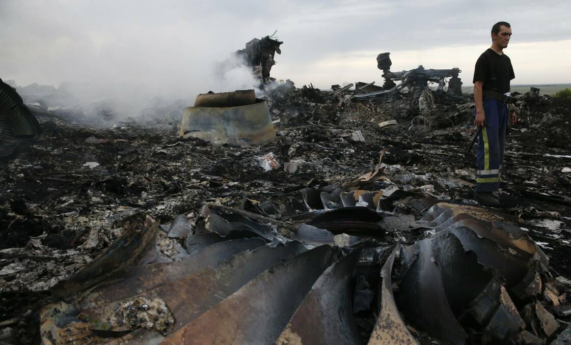An Emergencies Ministry member walks through the Malaysia Airlines MH17 crash site near the settlement of Grabovo in the Donetsk region. Picture: REUTERS