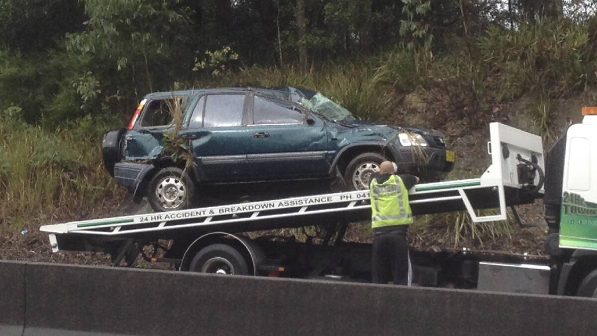 One of the cars involved in the Mount Ousley Road accident is removed. Picture: CHRISTOPHER CHAN