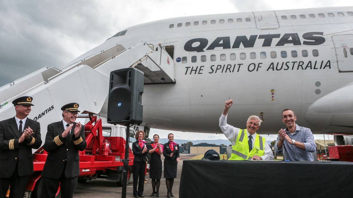 Celebrate: HARS president Bob De La Hunty with QANTAS chief executive for international Gareth Evans at the handover of a Qantas 747-400 to the HARS Museum in Albion Park. Picture: ADAM McLEAN