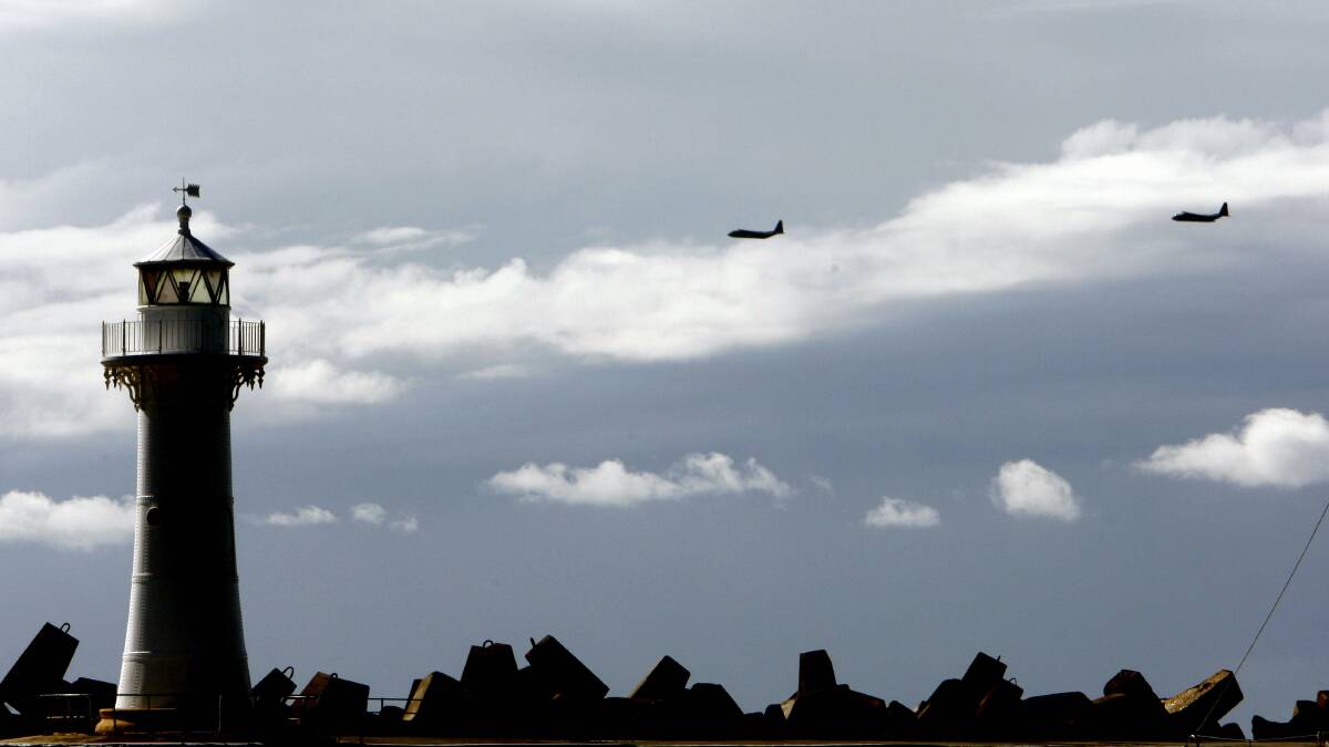 RAAF aircrafts conduct a tactical flying formation in Wollongong on Thursday. Picture: ANDY ZAKELI