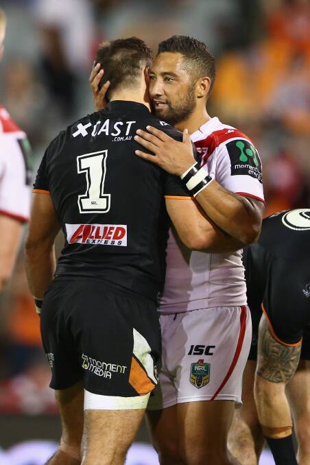 James Tedesco of the Tigers and Benji Marshall of the Dragons embrace after the match during the round two. Picture: GETTY IMAGS