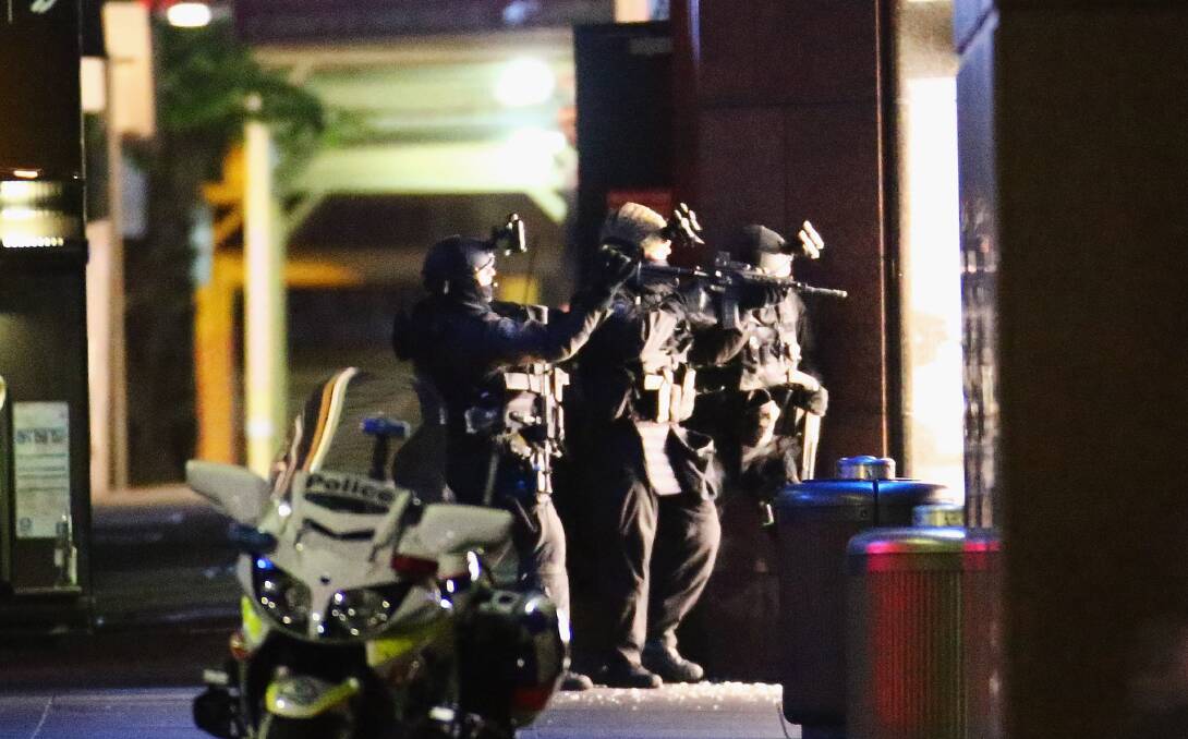 Armed police take aim outside the Lindt Cafe. Picture: GETTY IMAGES