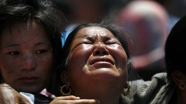 Relatives of mountaineers killed in the avalanche cry during the funeral ceremony in Kathmandu on Monday. Picture: AP
