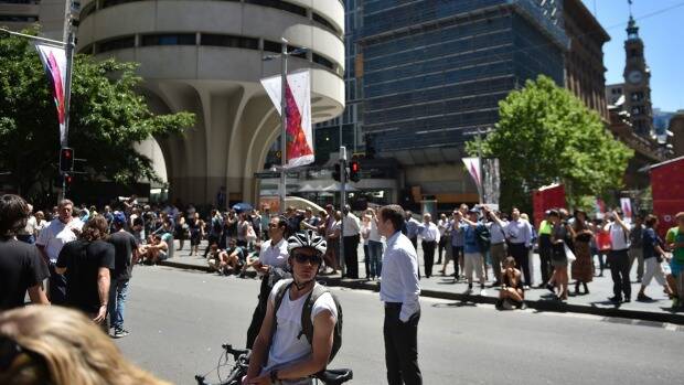 Workers gather at Martin Place during the siege at the nearby Lindt cafe. Photo: AFP