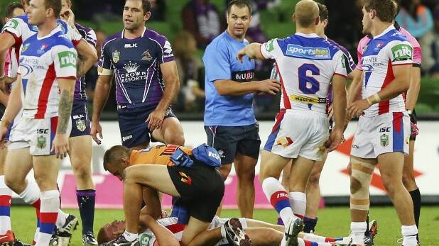 Cameron Smith stands in the background as Alex McKinnon receives attention. Photo: Getty Images