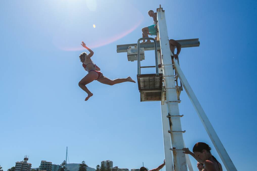 Ashley Bagnat jumps off the weigh station at Wollongong Harbour. Picture: ADAM McLEAN