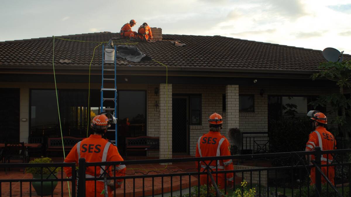 NSW SES Kiama unit work on the house hit by lightning. Picture: NSW SES