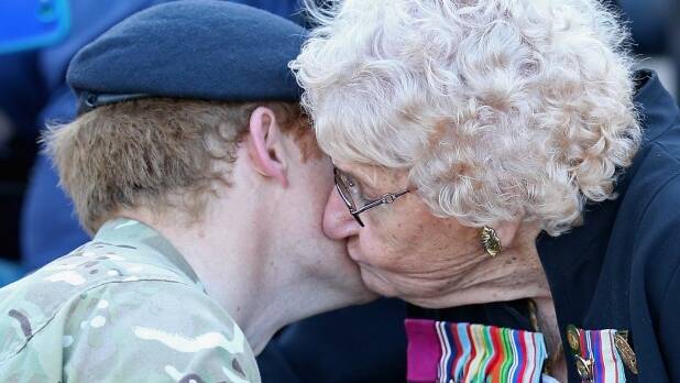 Prince Harry meets Daphne Dunne, who is wearing her husband's Victoria Cross. Photo: Getty Images
