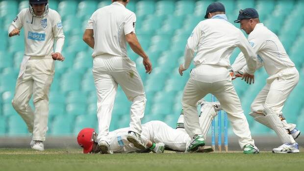 Hughes falls face down on the pitch. Photo: Getty Images