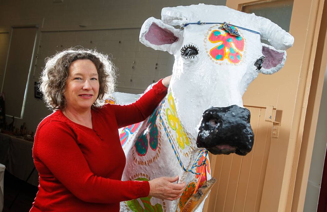 Kiama council’s community services director Clare Rogers with Daisy the Cow. Picture: CHRISTOPHER CHAN