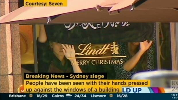 A screengrab apparently showing a flag being flown inside the Lindt Chocolat Cafe. Photo: Channel Seven