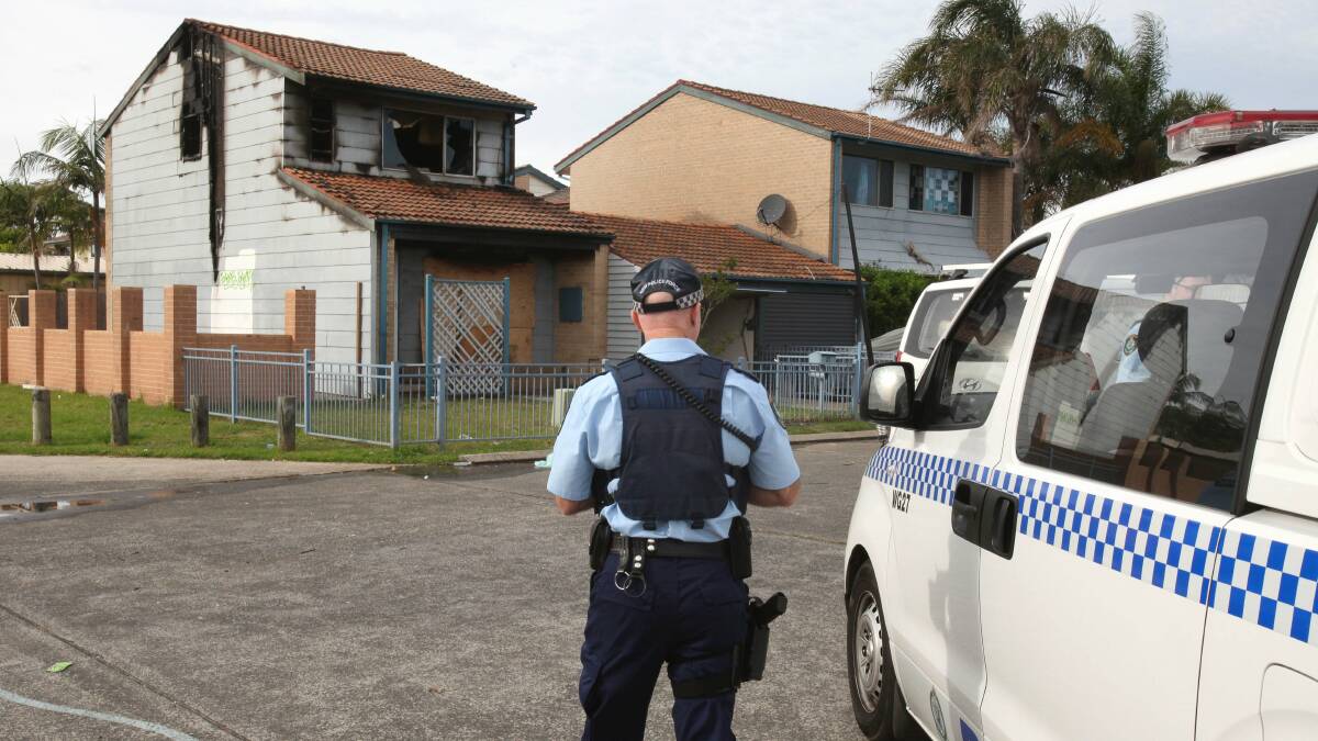 Police inspect the Bellambi house that was gutted by fire on Thursday. Picture: KIRK GILMOUR