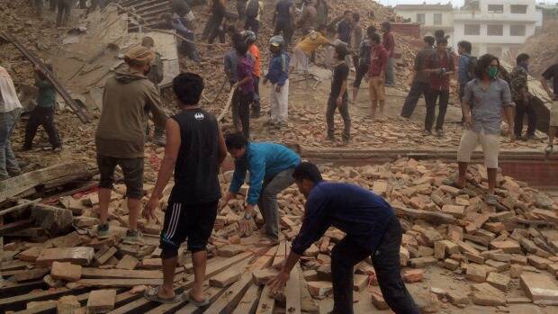 Rescuers at the site of a Kathmandu building that collapsed after Saturday's earthquake in Nepal. Photo: AP