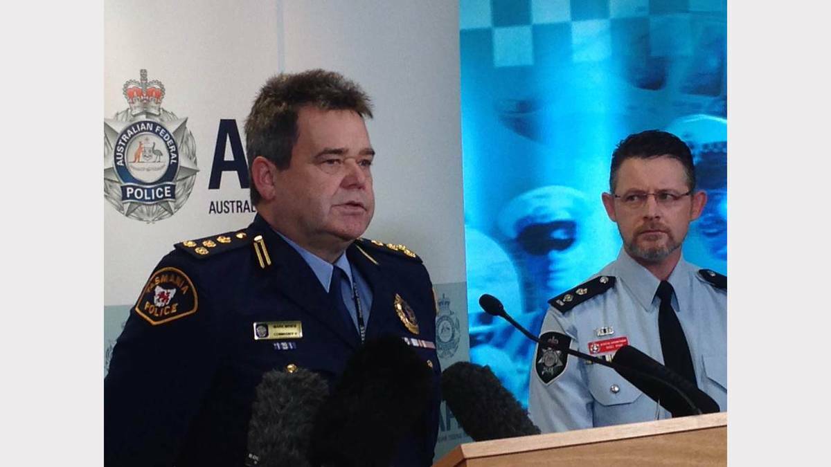 Acting Assistant Commissioner Mark Mewis and Australian Federal Police Detective Superintendent Nigel Ryan address the media in Hobart this morning.