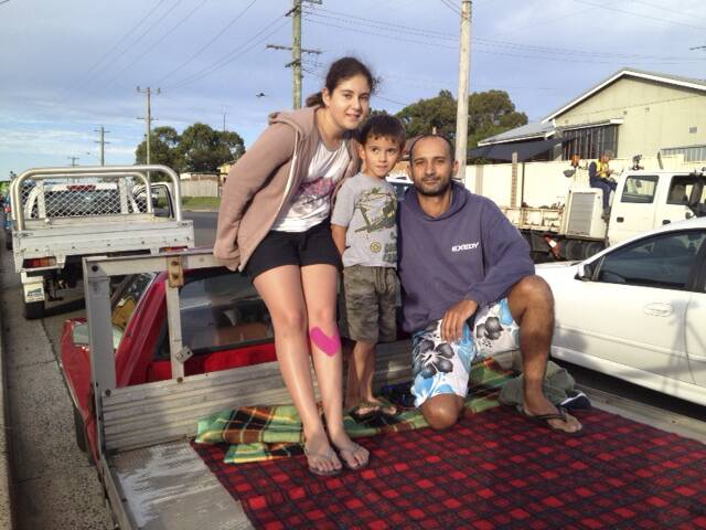 The Gouveia family waits on their ute for the stack crash. Picture: GREG TOTMAN