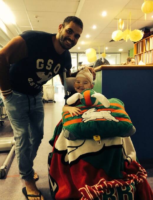 South Sydney Rugby League star Greg Inglis helps bring back some smiles for Bomaderry’s Jake Price. The toddler is recovering slowly in hospital after being severely injured in a car accident in April.