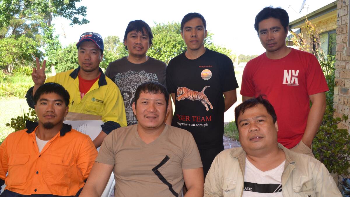 Filipino workers, back: Ricky Marquez, Alan de Ocareza, Victor Villegas, Alvin Gallo. Front: Norman Telino, Christopher Vilas, Jeszar Banajera.