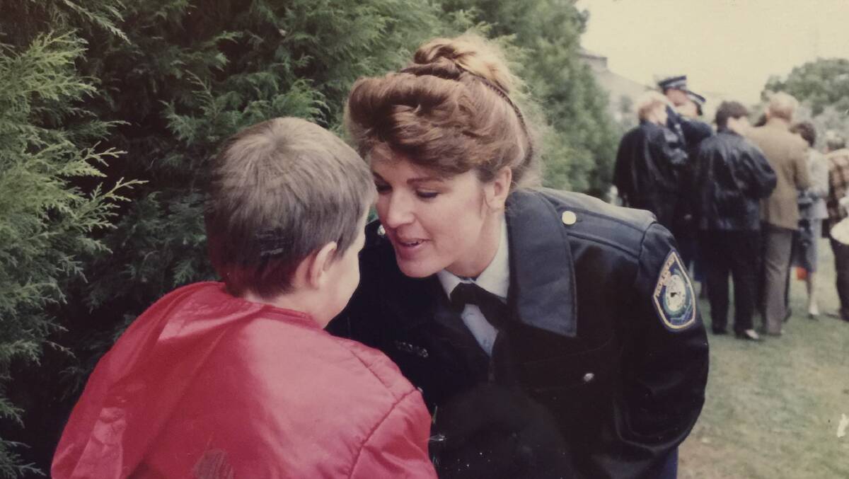 Sandra Mullaly tends to a child during her time as a member of the Wollongong police force.