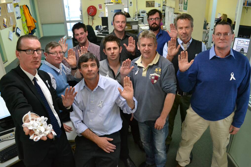 Duncan Nisbet (far left) leads some of the South Coast Register men in the White Ribbon oath: (clockwise from left) Robert Crawford, Patrick Fahy, Nick Beale, Jon Arcus, John Hanscombe, Simon Brown, Andrew Buckle, Matt Bartley and Damian McGill.