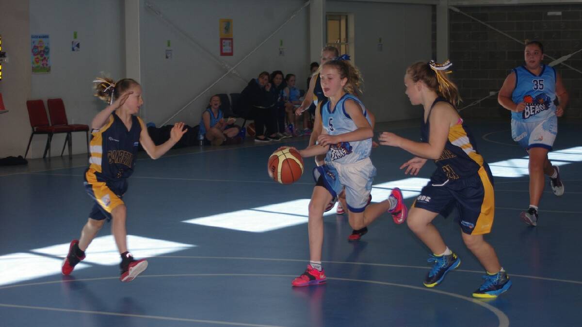 IN CONTROL: Goulburn Under 12s division two player  Hannah Bowles dribbles the ball down the St Peter and Paul’s School court with Eden Robertson behind (right) as Canberra’s Ashley Bowden and Joeleigh Esterhuizen move in to disrupt her transition. Photo: Darryl Fernance.
