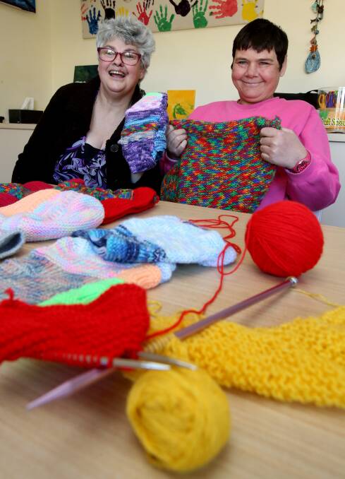 Greenacres clients Meegan Lenham and Kathleen Arnold knitting pouches for injured native animals. Picture: ROBERT PEET