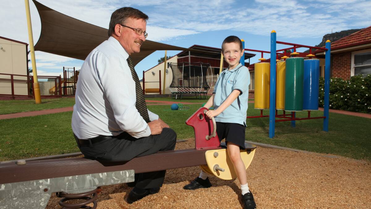 Aspect South Coast School principal Bruce Rowles with student Riley McConville last year. The school is raising funds to replace its Corrimal playground. Picture: DAVE TEASE