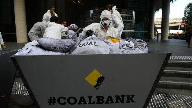 Greenpeace activists deliver a load of coal to the front of the Commonwealth Bank's Harbour Street office in Sydney on Monday to highlight the consequences of its fossil fuel lending policies. Photo: Greenpeace/James Alcock
