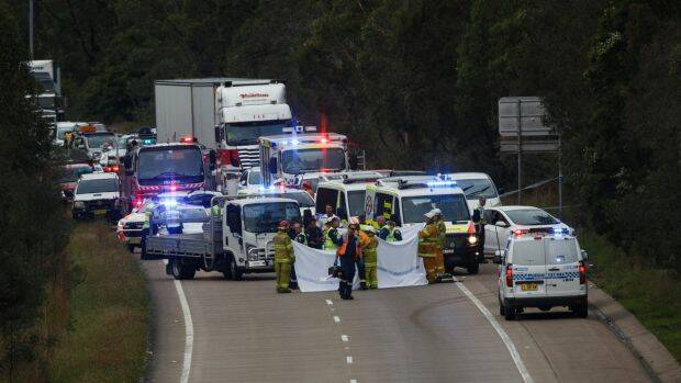 Emergency services at the scene of a fatal accident on the M1 Motorway at Cameron Park, between George Booth Drive and Link Road. Photo: Max Mason-Hubers
