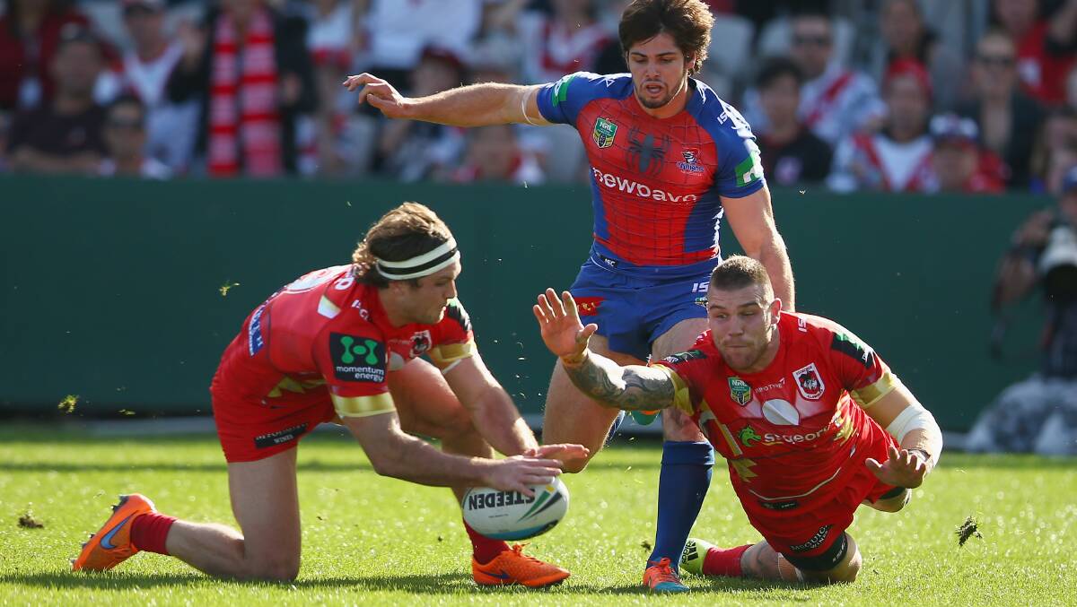Hanging on: Mitch Rein (left) and Josh Dugan scramble for the ball during Sunday's win over Newcastle at Kogarah. Picture: GETTY IMAGES