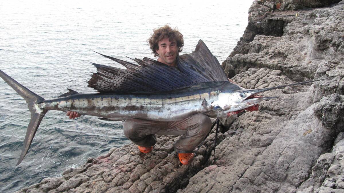 Wollongong land-based game fisherman Jason Stanley with his sailfish catch earlier this year.