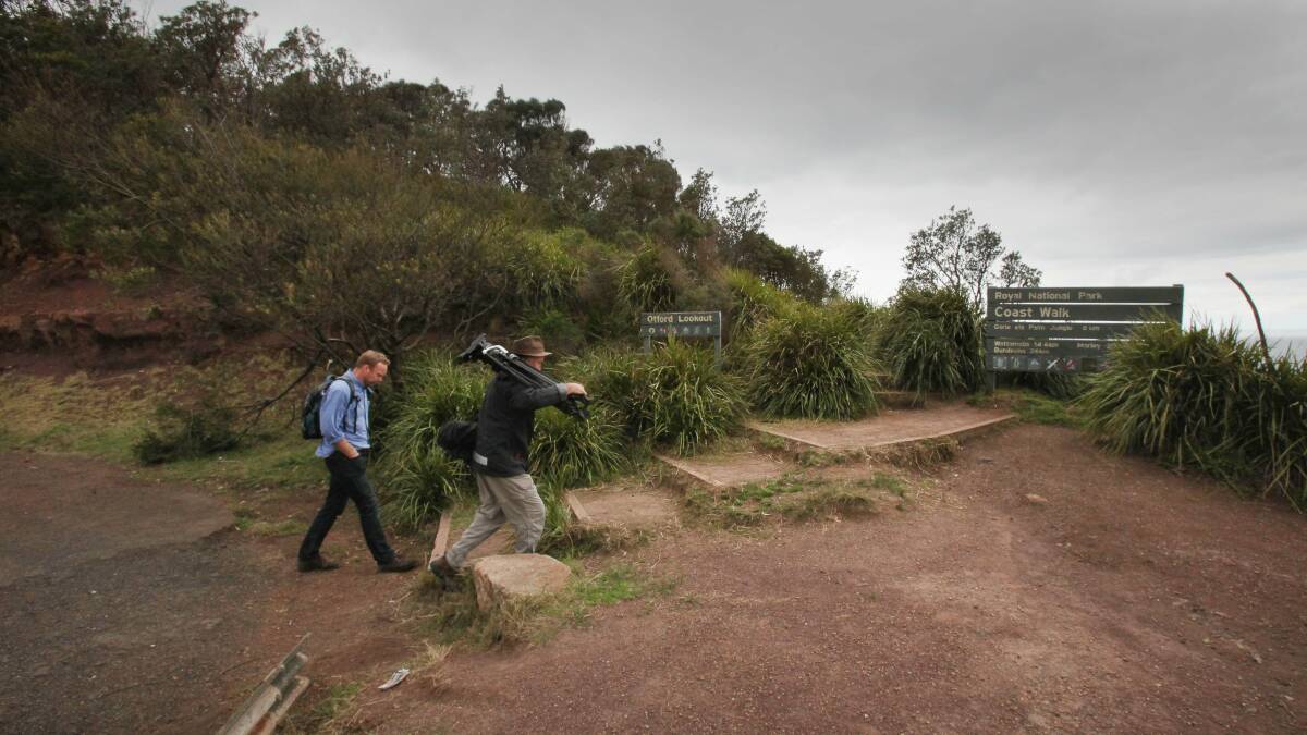News crew prepare to make the two kilometre walk to Werrong Beach from Otford where the body of a man was located. Picture: KIRK GILMOUR