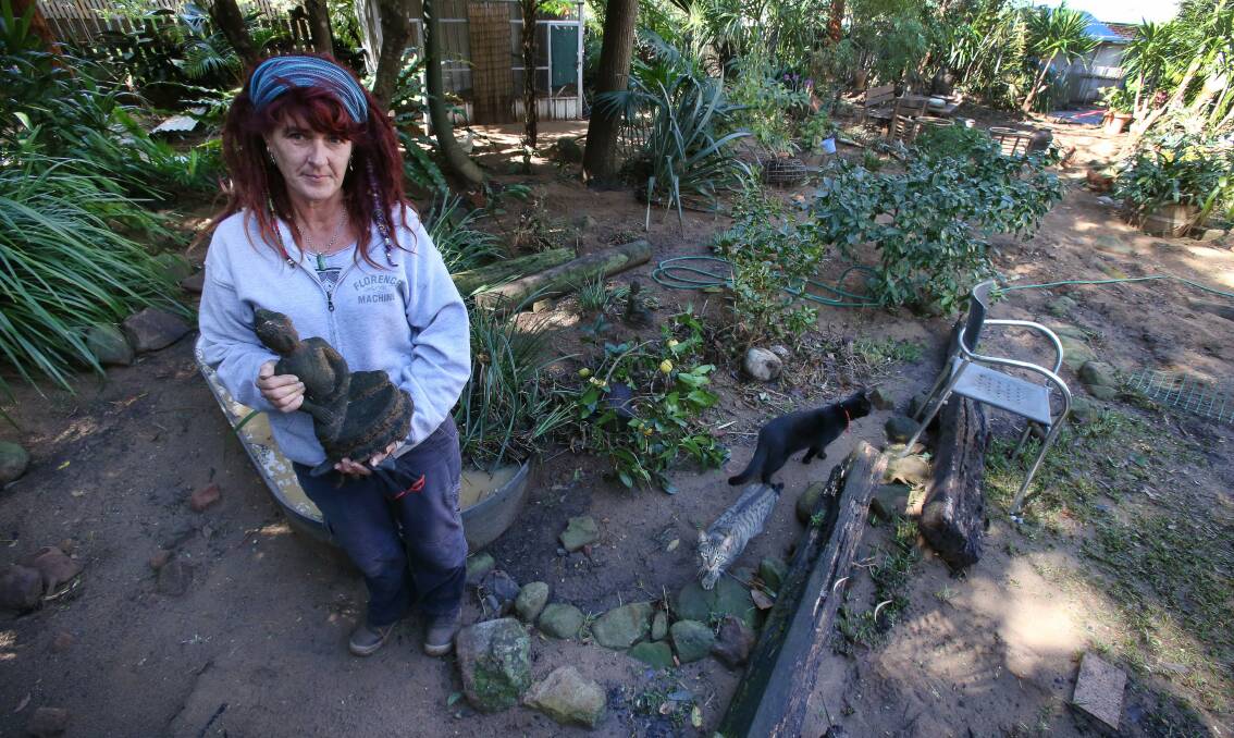 Ms Vincent in the seriously damaged backyard of her Lachlan Street property. 